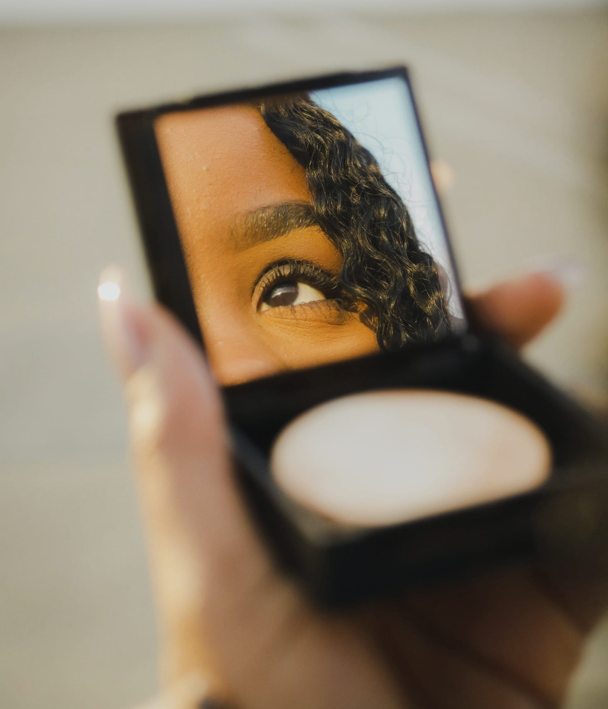 a woman holding a compact compact compact compact compact compact compact compact compact compact compact compact