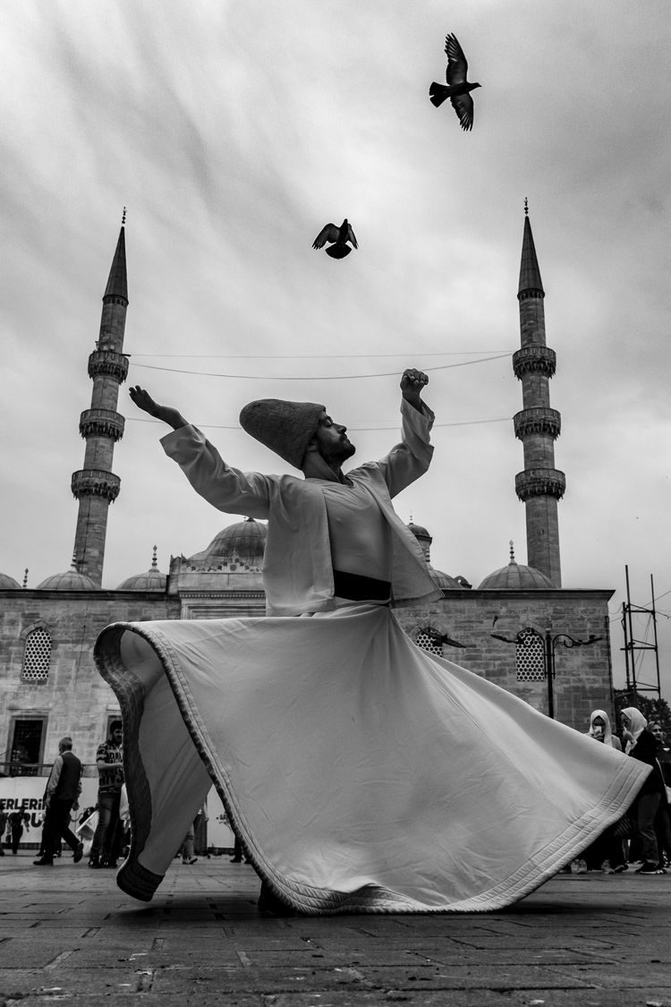 Photo by Soner Arkan: https://www.pexels.com/photo/man-performing-sufi-whirling-against-a-mosque-12943931/